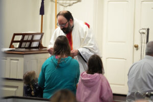 Photo of Fr. David Radzik offering communion